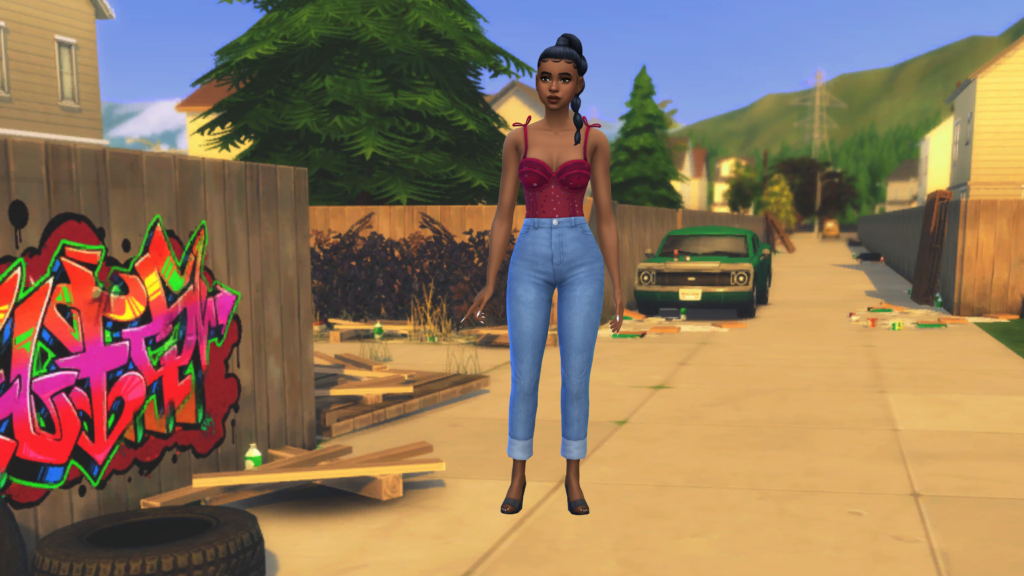 Un sim con jeans de cintura alta y un body corset rojo con el pelo recogido en una trenza. Este sim está parado en una calle sucia de Los Sims 4.