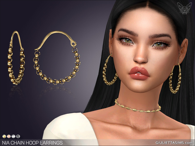 Un Sim con cabello largo castaño oscuro y ojos verdes. Lleva mucho brillo de labios y un collar dorado. Lleva puestos unos pendientes de Los Sims 4 que son de un dorado apagado con bolas y cadenas.