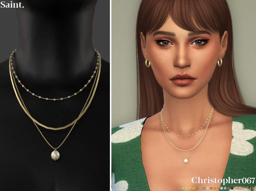 Un sim con cabello castaño y flequillo recto ligeramente hacia un lado. Llevan puesto un suéter verde con flores blancas y un collar en capas.