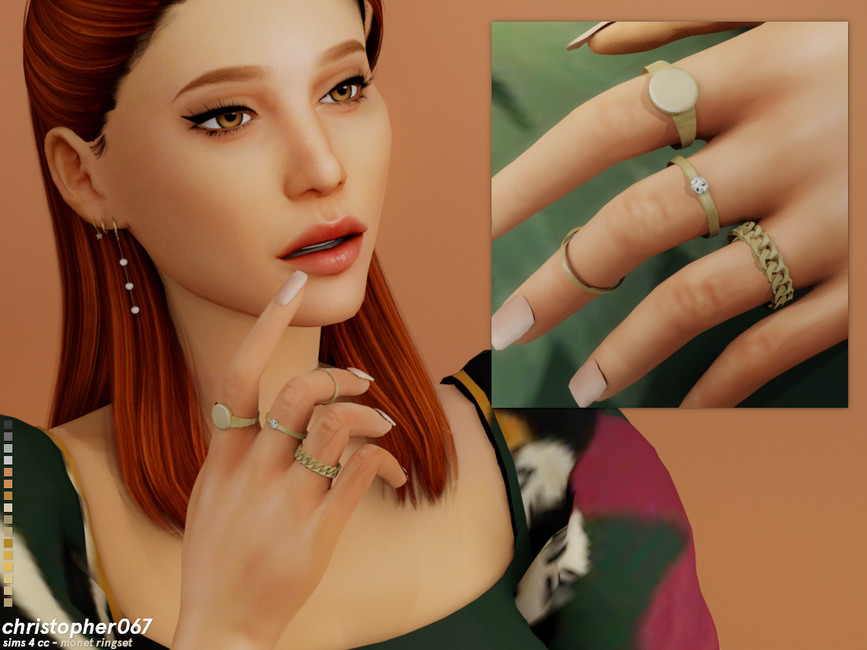 Un Sim con cabello rojo usando un vestido verde estampado con montones de anillos en sus manos. 