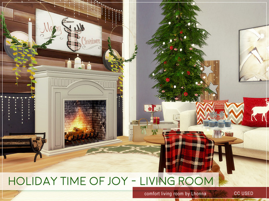Un conjunto de sala de estar navideño, con un montón de cojines navideños, una manta, un árbol alto y delgado y una chimenea.