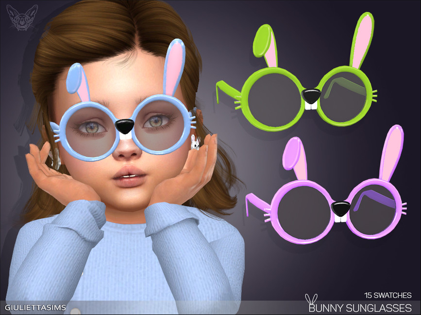 Un Sim con cabello castaño y peinado hacia un lado que lleva un suéter azul claro y un par de gafas de sol azules que hacen que el Sim parezca un conejo.