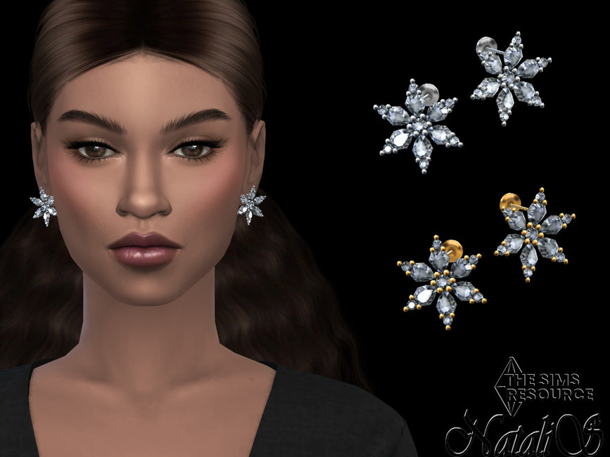 Una sim con cabello castaño y ojos marrones que lleva puestos unos grandes pendientes de copo de nieve de Sims 4 cc de Navidad.